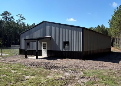Enclosed metal workshop with 12x12 roll-up door