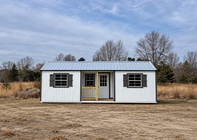 Finished cabin with windows, shutters, and a front porch