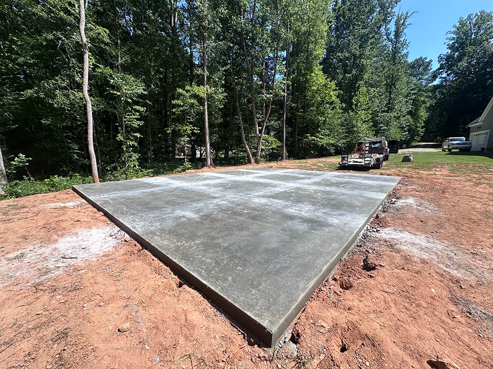 Fresh concrete pad ready for a shed delivery