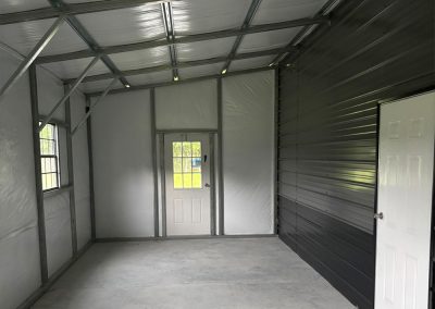 Interior of a metal workshop with workbench and storage