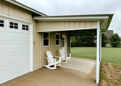 Metal building overhang with windows, lights, and 9 lite door