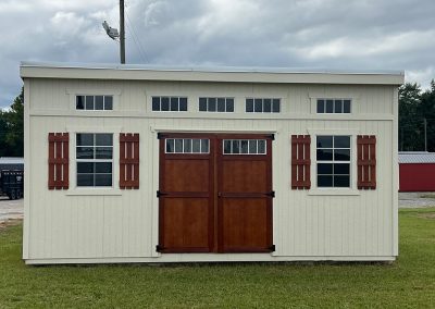Sun studio with stained double doors, shutters, and transom windows