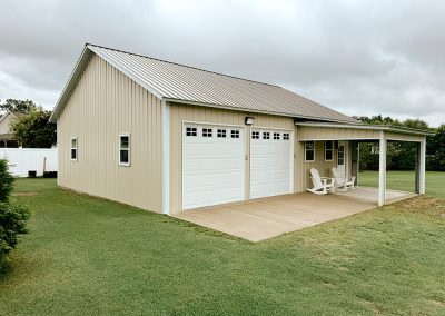 Two-car metal garage with white roll-up doors in Wilson, NC